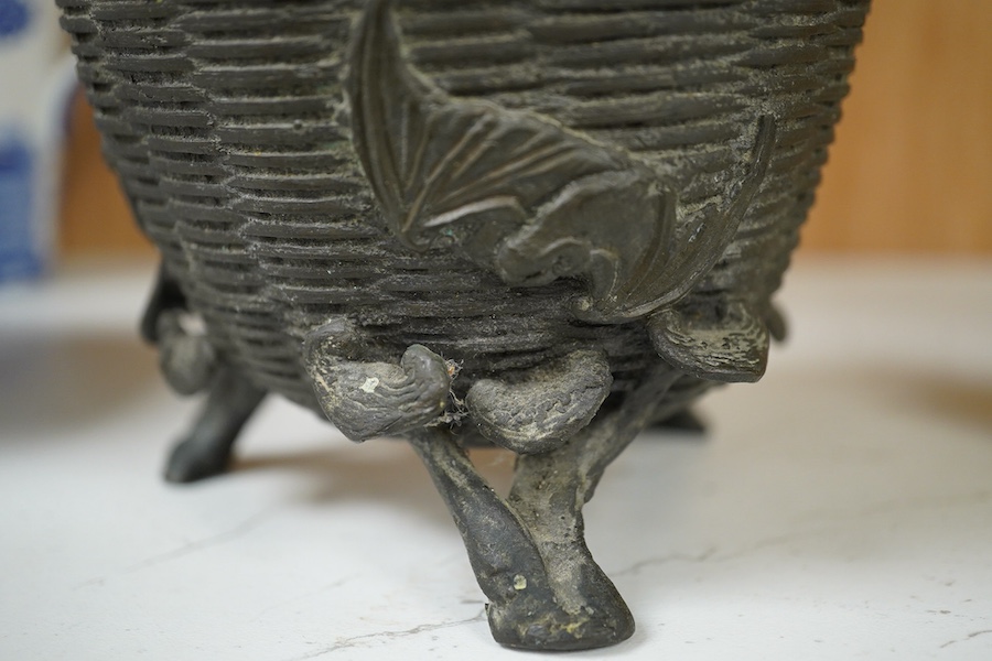 A Japanese bronze censer shaped as a basket on three legs. 8.5cm high.